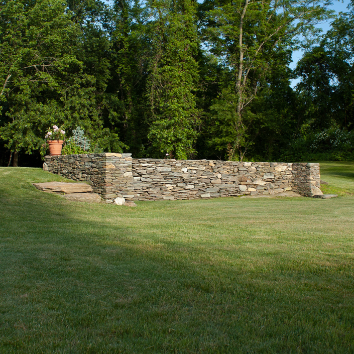 Stone wall built from remnants of former barn foundation in Chester, Connecticut